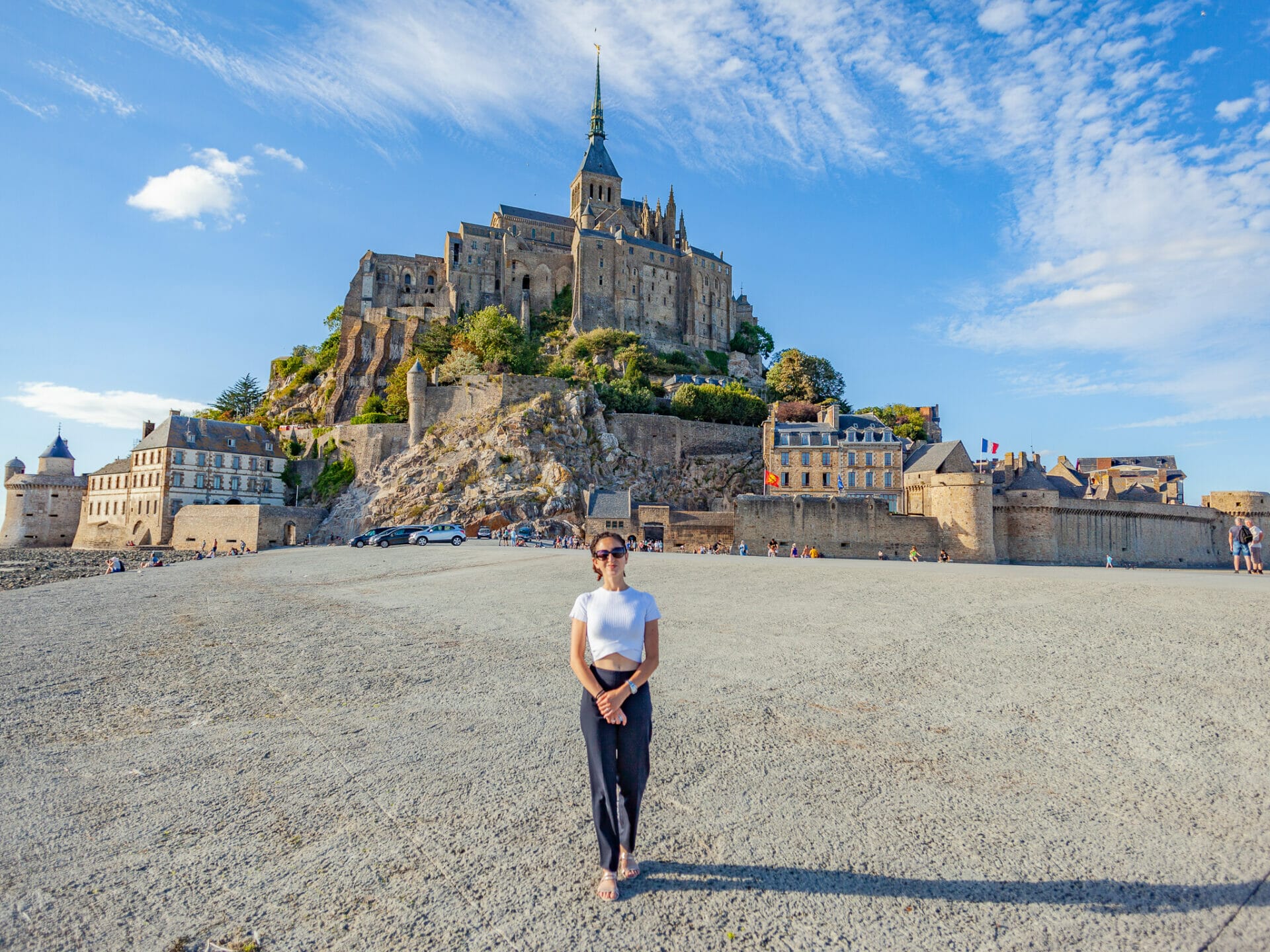 Woman standing on tidal plains at Mont Saint Michel