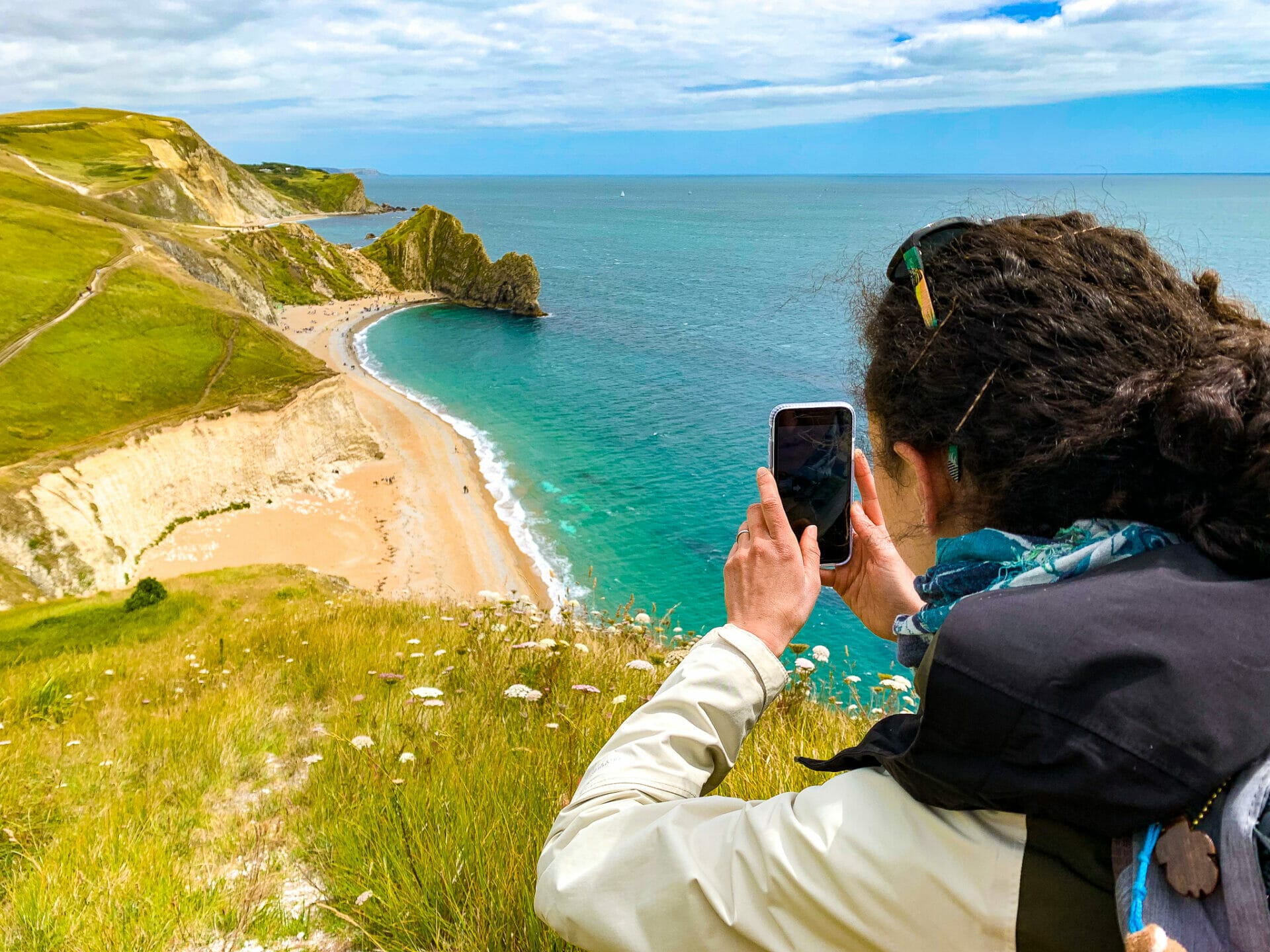 Woman photographing  shore iPhone XR Essential gear for Travel Photography